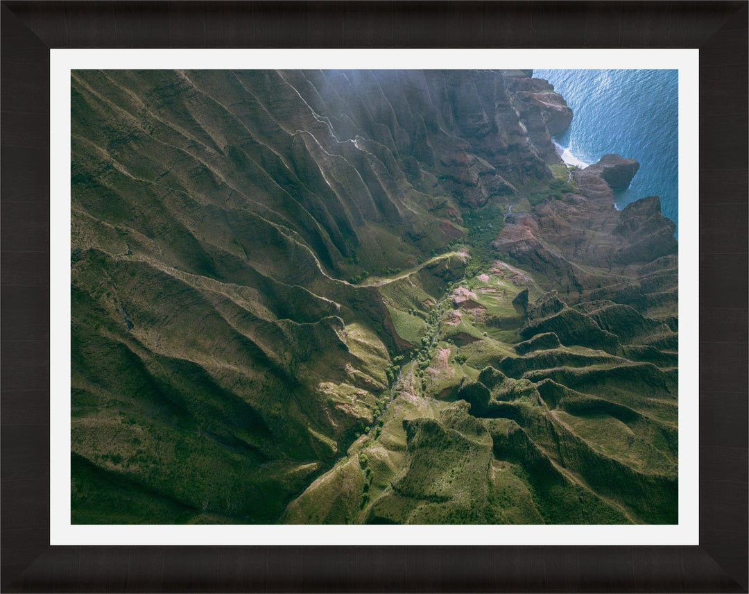 Over the Edge | Aerial Odyssey over Na Pali - Living Moments Media - 3500-5500, 800-3500, Abstract, Acrylic, aerial, Artwork, beach, Best Moments, Best Sellers, black, blue, Canvas, Coast, Cove, green, Hawaii, Helicopter, Honopu Beach, horizontal, Island, Kauai, Maui, Metal, Moody, Mountains, Na Pali Coast, new arrivals, New Moments, ocean, open-edition, over-5500, Prints, rocks, sand, size-18-x-24, size-30-x-40, size-42-x-56, Surf, trail, Trees, Visual Artwork, waves