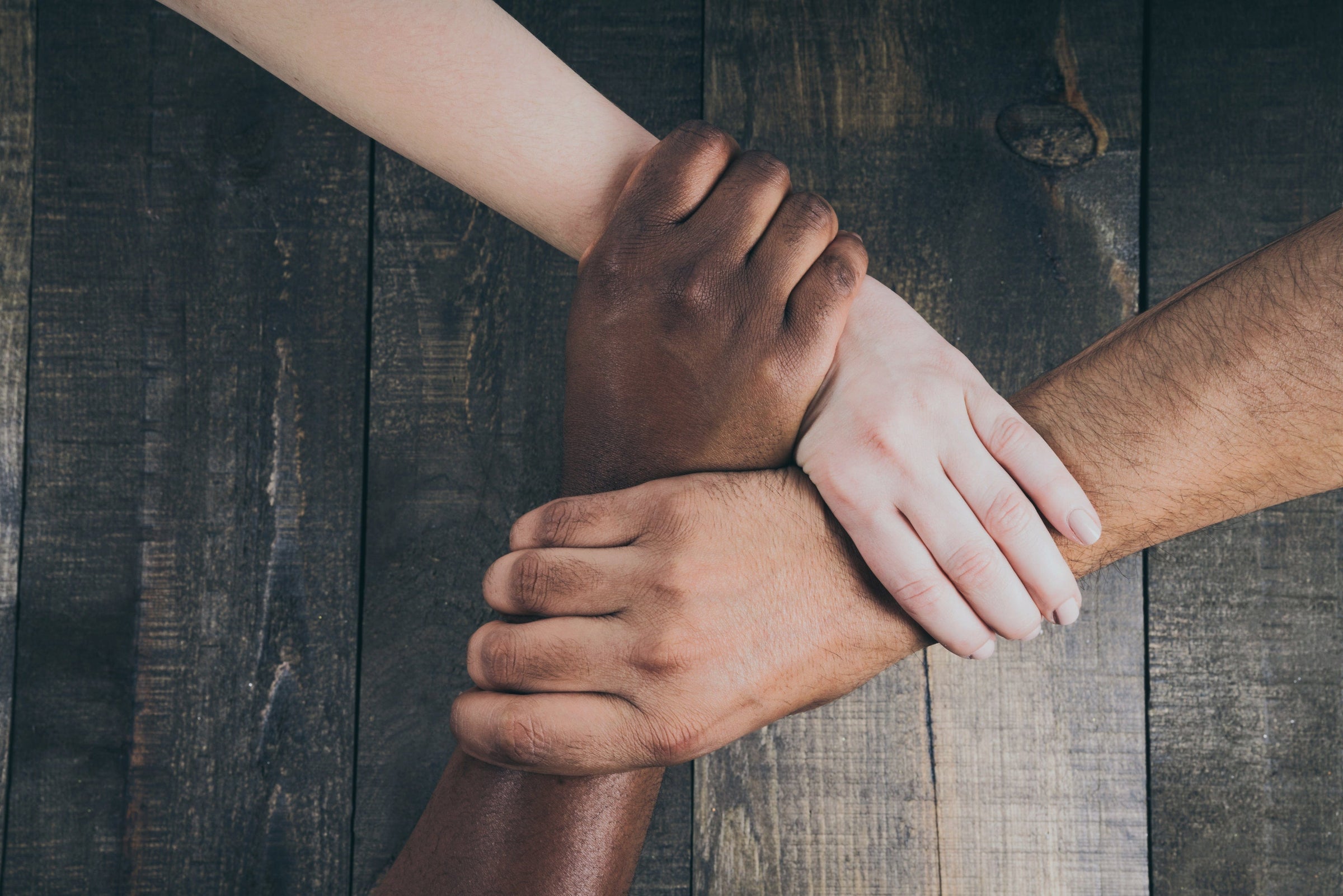team-hands-linked-together Living Moments Media