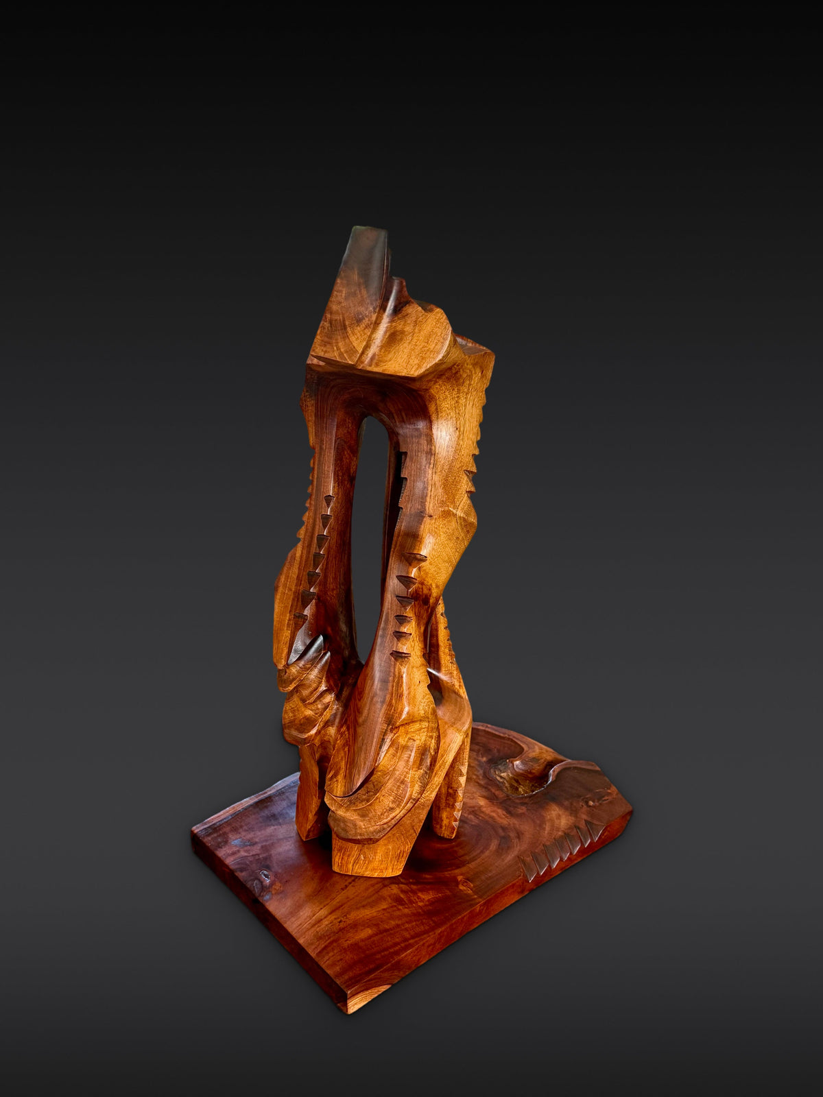 Avi Molinas’s Lawaiʻa wood sculpture, carved in kou with a milo base, photographed from the front.