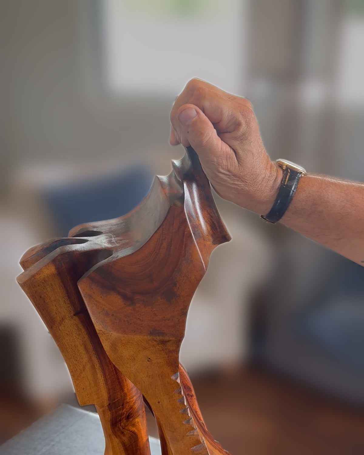 Avi's hand resting on the oiled top of the sculpture