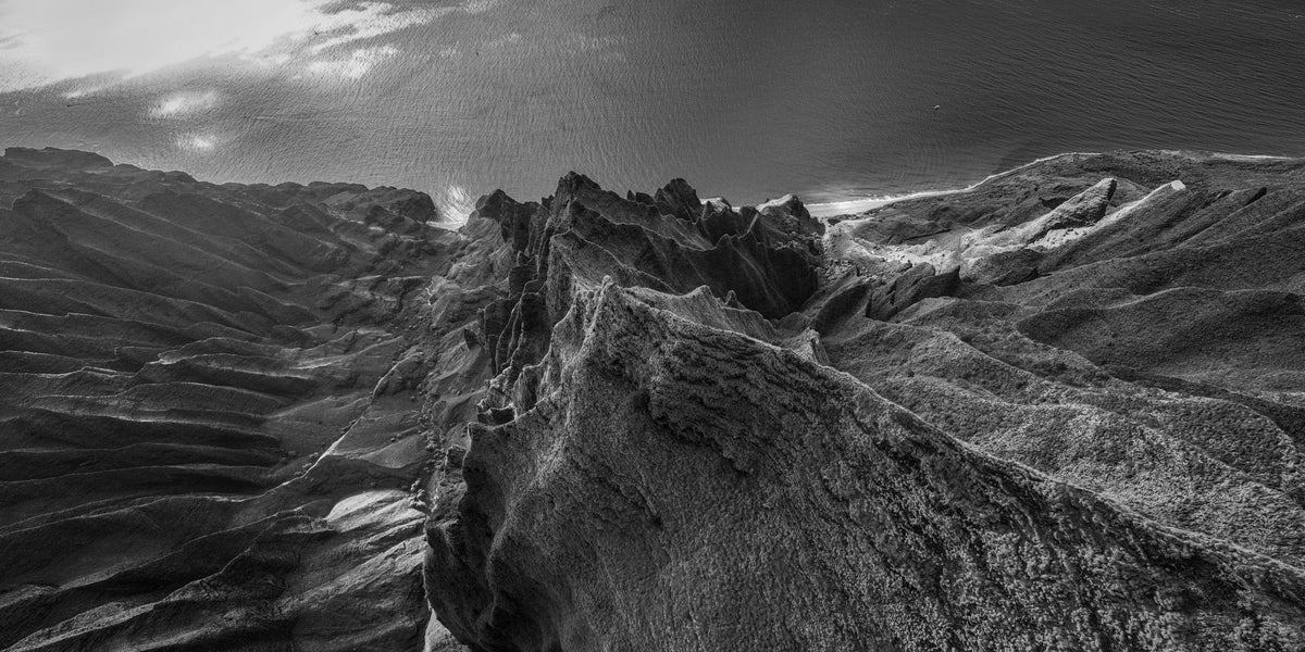 Marvel in Monochrome | Bird's Eye View Over Na Pali & Kalalau - Living Moments Media - 3500-5500, 800-3500, Abstract, Acrylic, aerial, Artwork, beach, black, Black & White, Canvas, Coast, Cove, Hawaii, Helicopter, Honopu Beach, horizontal, Island, Kauai, Aluminum, Monochromatic, Moody, Mountains, Na Pali Coast, new arrivals, New Moments, ocean, open-edition, over-5500, panoramic, Prints, rocks, sand, size-20-x-40, size-40-x-80, Surf, trail, Trees, Visual Artwork, waves, White