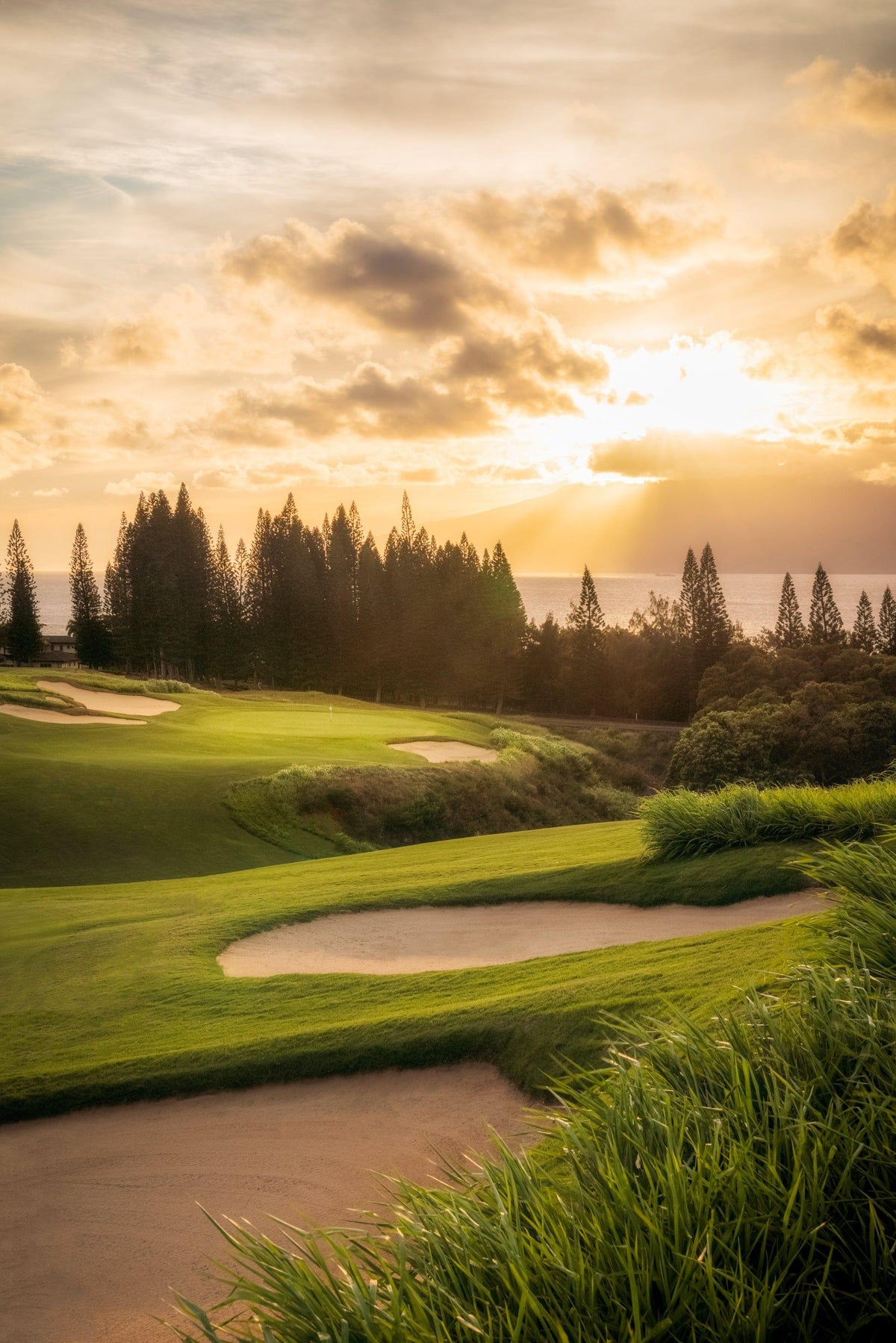 Sunset's Gateway by Lance Ehrecke, sunset photograph of Hole 1 at Kapalua's Plantation Course with Molokaʻi beyond.